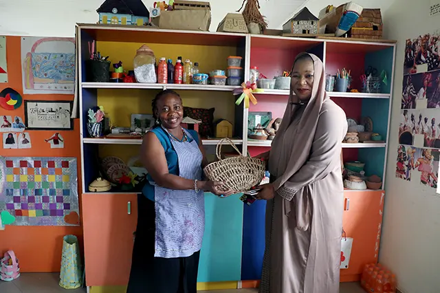 NOWA National President, Mrs. Ijeoma Ogalla, represented by Vice President of NOWA, Mrs. Zainab Akpan, receiving gift from NOWA Schools, Karshi